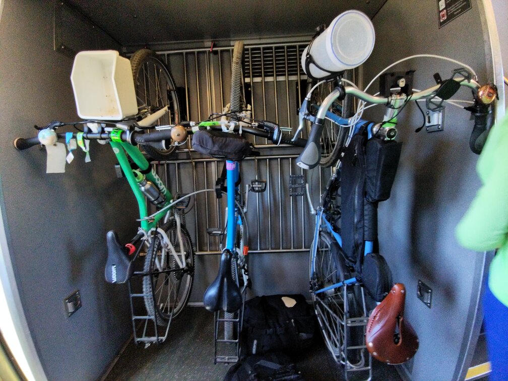 Bikes on a 3-rack on Capitol Corridor train car. Bikes are not fully locked yet in this picture.